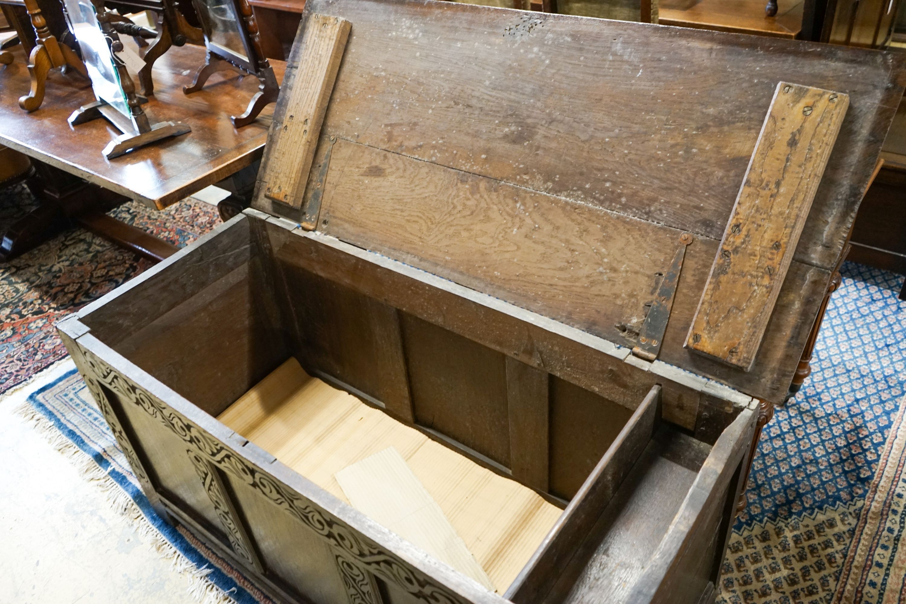 A late 17th / early 18th century carved and panelled oak coffer, length 136cm, depth 58cm, height 66cm